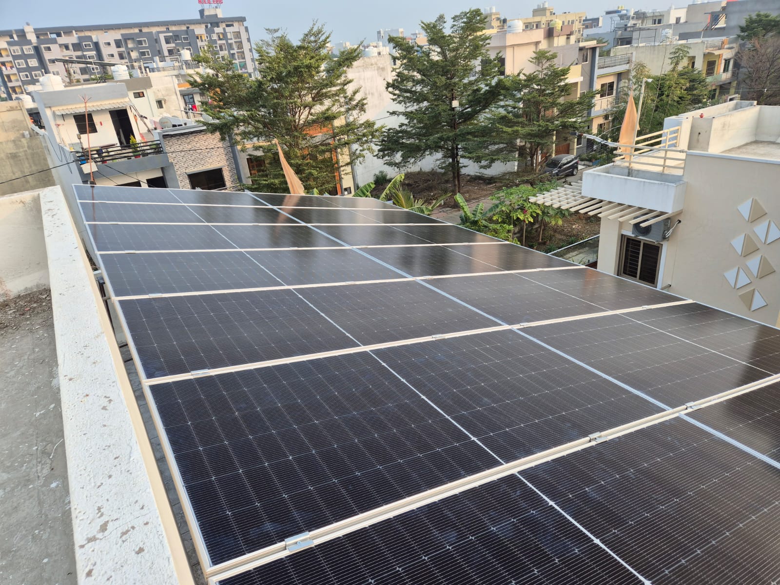 Rooftop solar panel array installation on residential house terrace